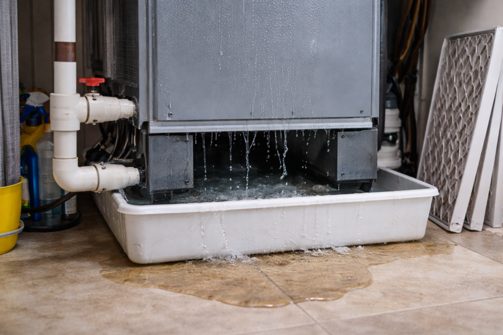 Air conditioning unit leaking water with visible pooling underneath